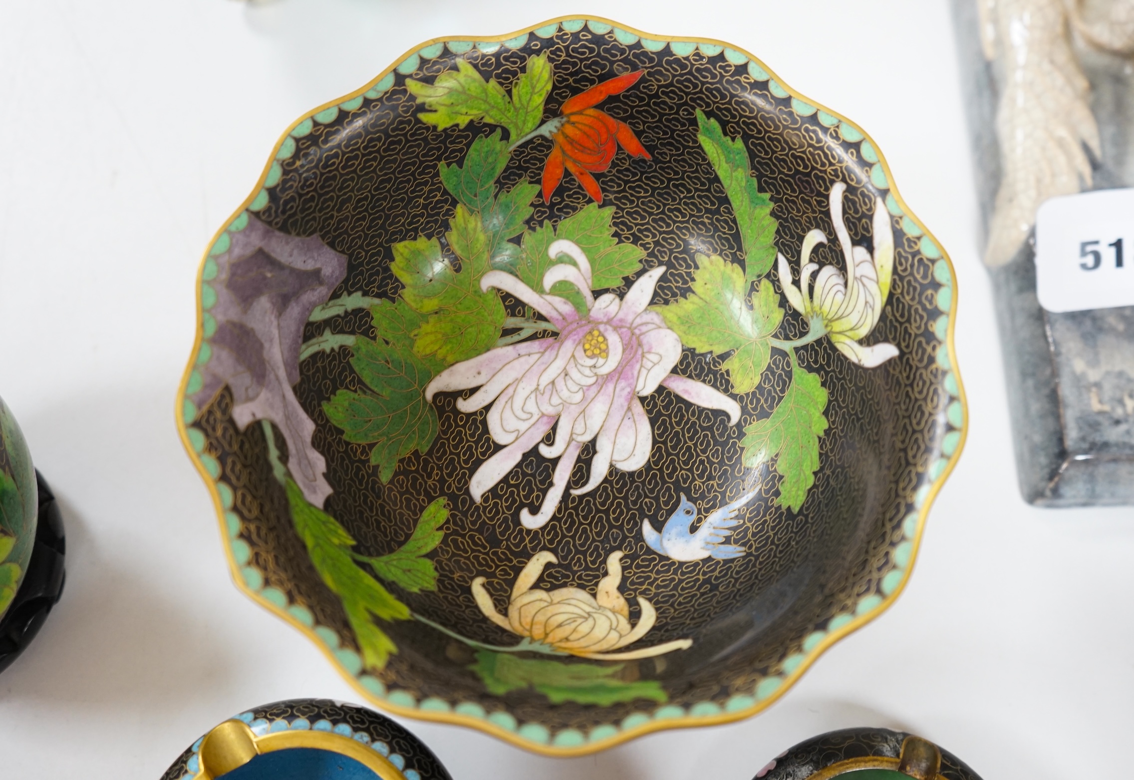 A collection of Chinese cloisonné enamel vessels, some with stands, all worked on a black background in floral designs, plate 26cm diameter. Condition - good